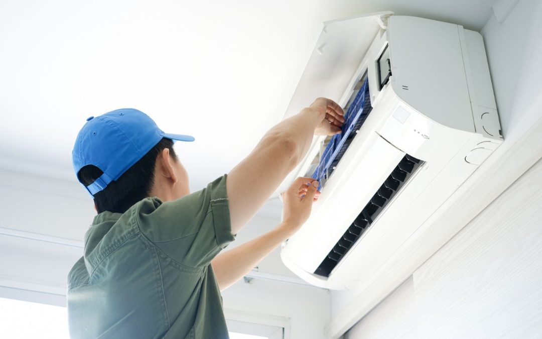Air conditioning technician maintaining an indoor mini split system in Draper, UT